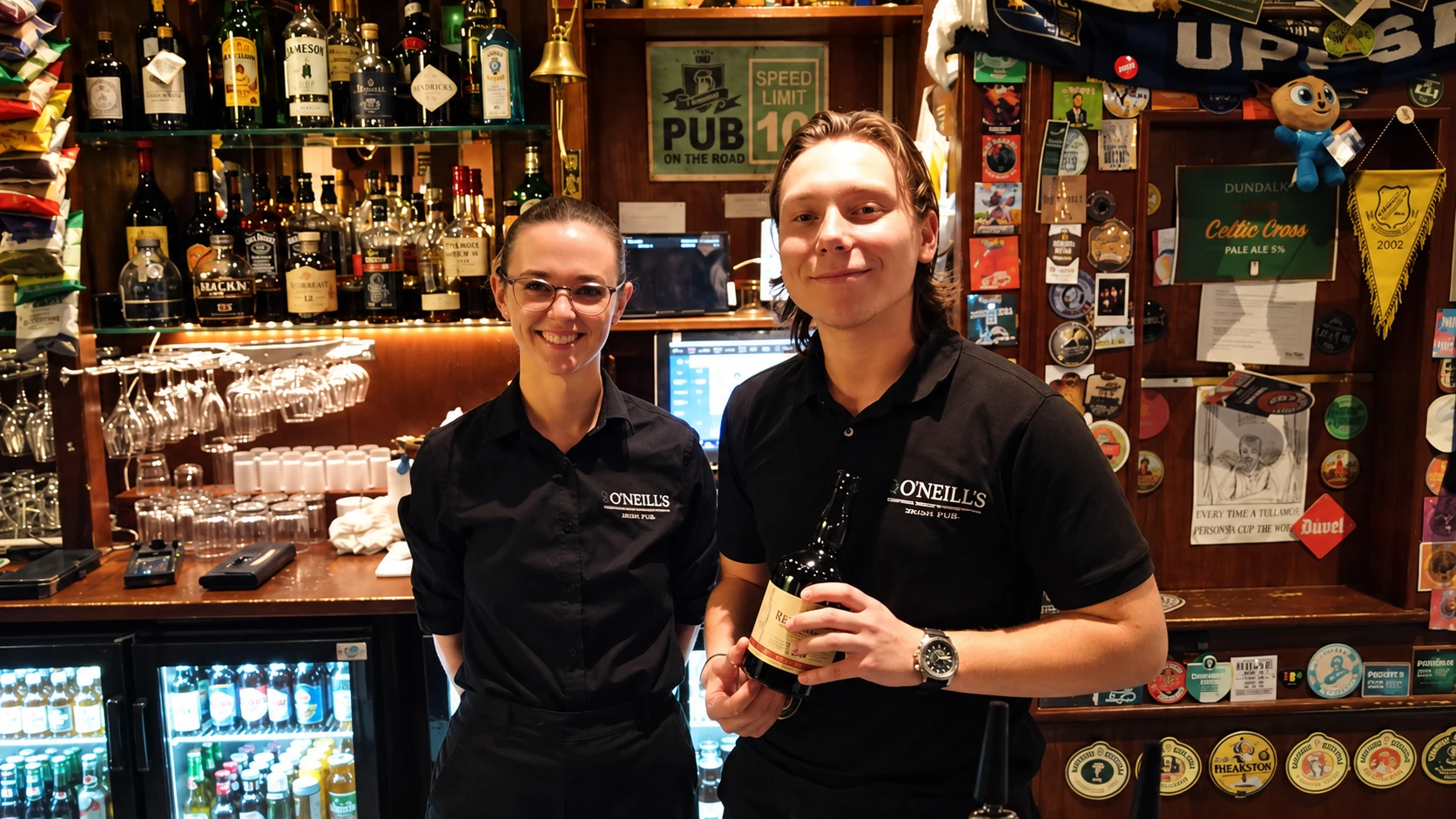 O’Neill’s staff behind the bar, AI-edited image